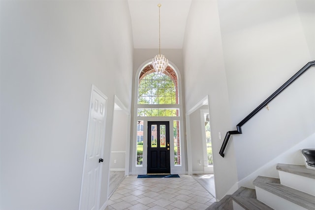 7147 Hot Creek Trce, Humble, TX 77346 - entryway with a high ceiling, stairs, and a chandelier