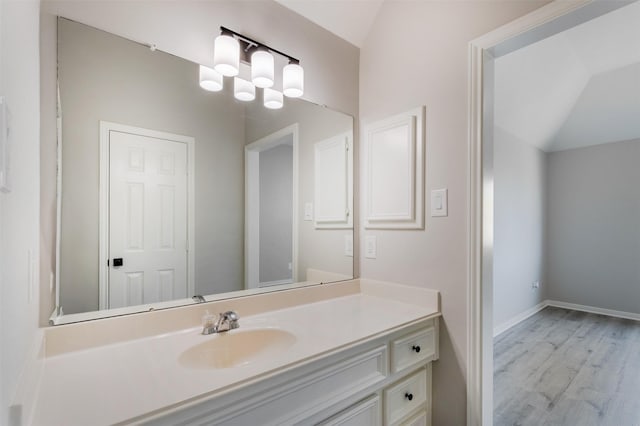 7147 Hot Creek Trce, Humble, TX 77346 - bathroom featuring vanity, wood finished floors, lofted ceiling, and a chandelier