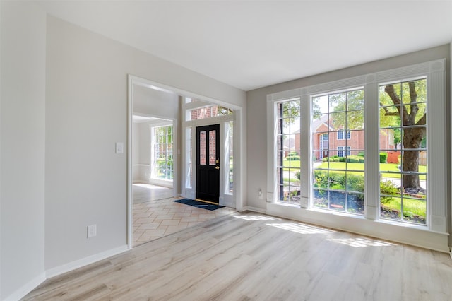 7147 Hot Creek Trce, Humble, TX 77346 - entryway with baseboards and wood finished floors