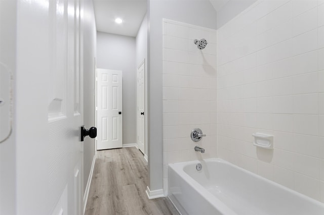 7147 Hot Creek Trce, Humble, TX 77346 - bathroom with washtub / shower combination and wood finished floors