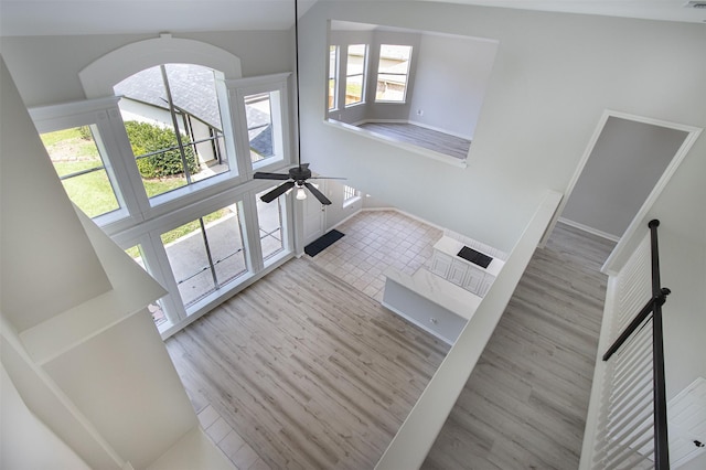 7147 Hot Creek Trce, Humble, TX 77346 - unfurnished living room featuring healthy amount of natural light, ceiling fan, and wood finished floors