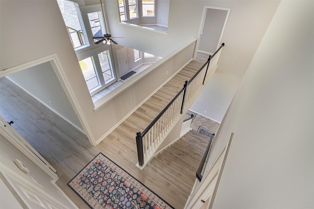 7147 Hot Creek Trce, Humble, TX 77346 - stairs with wood finished floors, ceiling fan, and a high ceiling