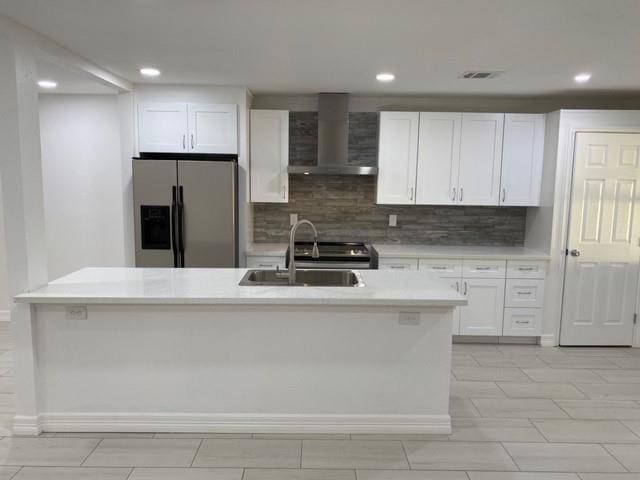 11319 Lockgate Ln, Houston, TX 77048 - kitchen featuring stainless steel fridge with ice dispenser, wall chimney range hood, white cabinetry, light countertops, and tasteful backsplash