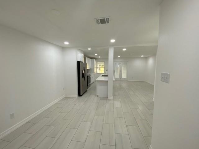 11319 Lockgate Ln, Houston, TX 77048 - unfurnished living room featuring recessed lighting and a sink