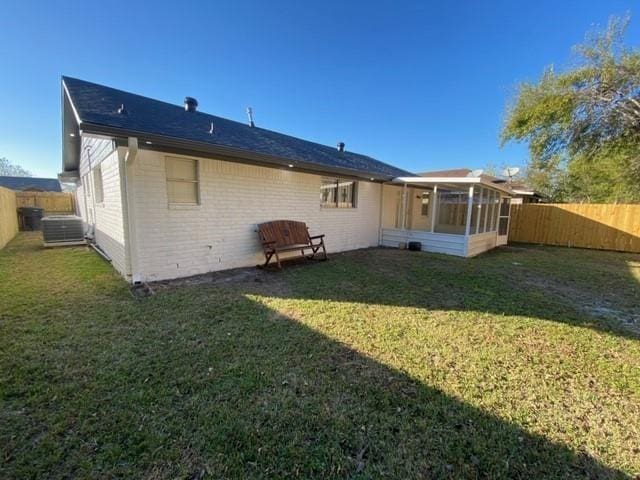 11319 Lockgate Ln, Houston, TX 77048 - rear view of house featuring a sunroom, a fenced backyard, and brick siding