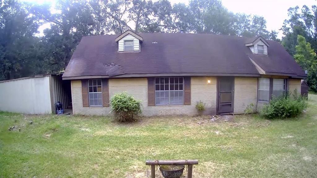 4723 Springfield Ln, Brenham, TX 77833 - new england style home featuring brick siding and a front yard