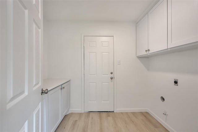1503 Bamwick Dr, Houston, TX 77090 - washroom with electric dryer hookup, light wood finished floors, and cabinet space