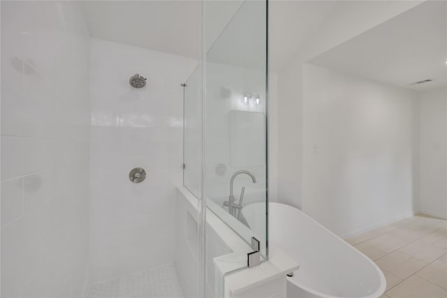 1503 Bamwick Dr, Houston, TX 77090 - bathroom featuring walk in shower, a soaking tub, and tile patterned floors