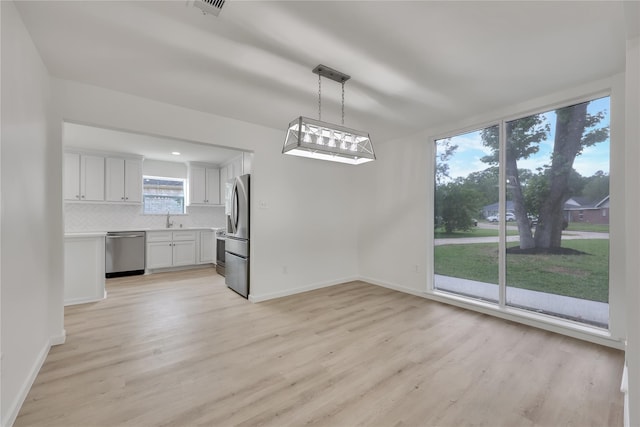 1503 Bamwick Dr, Houston, TX 77090 - unfurnished dining area with light wood-style flooring