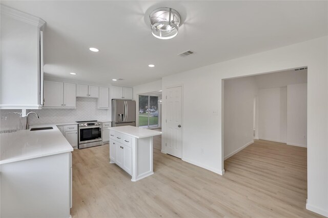 1503 Bamwick Dr, Houston, TX 77090 - kitchen featuring stainless steel appliances, light wood-style flooring, light countertops, a center island, and recessed lighting
