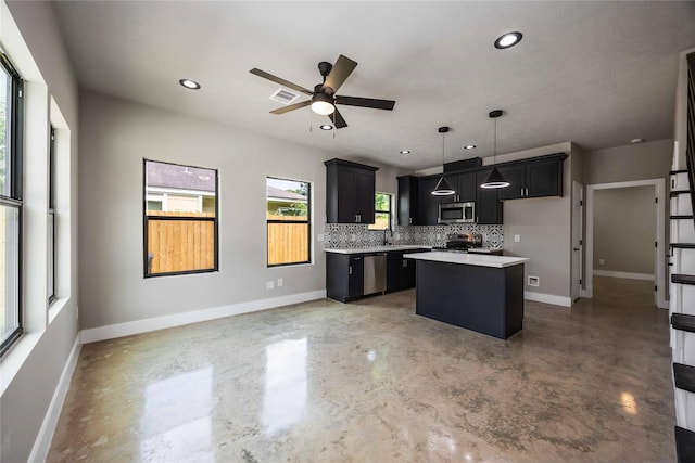 2407 Dolly Wright St, Houston, TX 77088 - kitchen with stainless steel appliances, concrete flooring, decorative backsplash, ceiling fan, and a center island