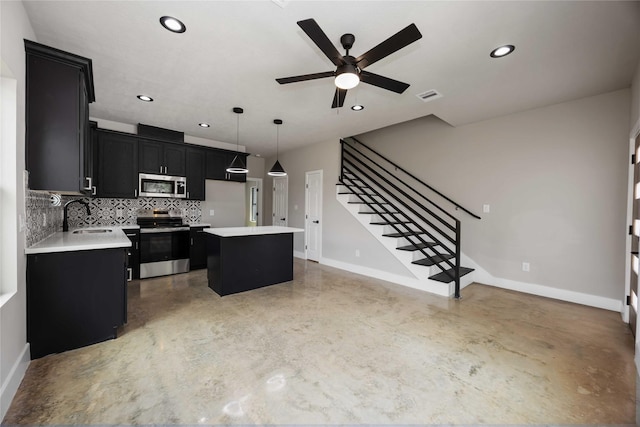 2407 Dolly Wright St, Houston, TX 77088 - kitchen featuring stainless steel appliances, dark cabinetry, finished concrete floors, a center island, and backsplash