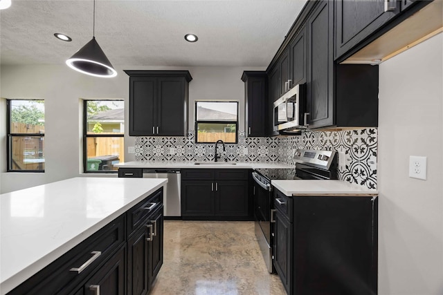 2407 Dolly Wright St, Houston, TX 77088 - kitchen featuring appliances with stainless steel finishes, dark cabinetry, light countertops, backsplash, and recessed lighting