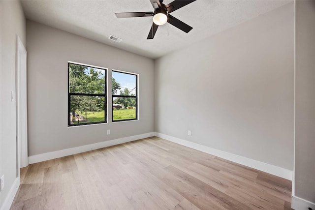 2407 Dolly Wright St, Houston, TX 77088 - empty room featuring light wood-type flooring, a ceiling fan, and a textured ceiling