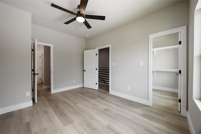 2407 Dolly Wright St, Houston, TX 77088 - unfurnished bedroom featuring a walk in closet, light wood finished floors, ceiling fan, and a closet