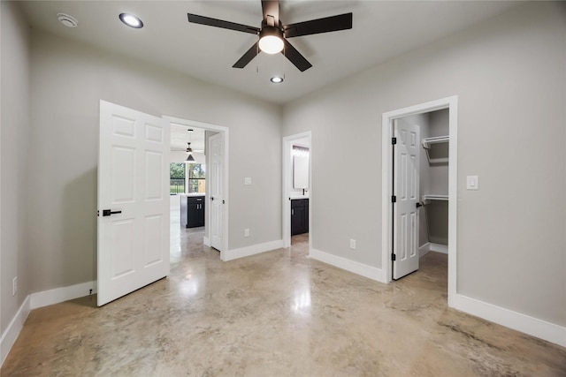 2407 Dolly Wright St, Houston, TX 77088 - unfurnished bedroom with finished concrete floors, a walk in closet, ensuite bath, recessed lighting, and a ceiling fan