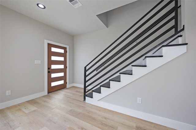 2409 Dolly Wright St, Houston, TX 77088 - foyer entrance featuring stairway, wood finished floors, and recessed lighting