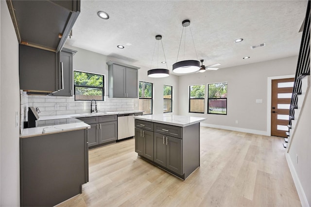 2409 Dolly Wright St, Houston, TX 77088 - kitchen with dishwasher, gray cabinets, decorative backsplash, ceiling fan, and recessed lighting