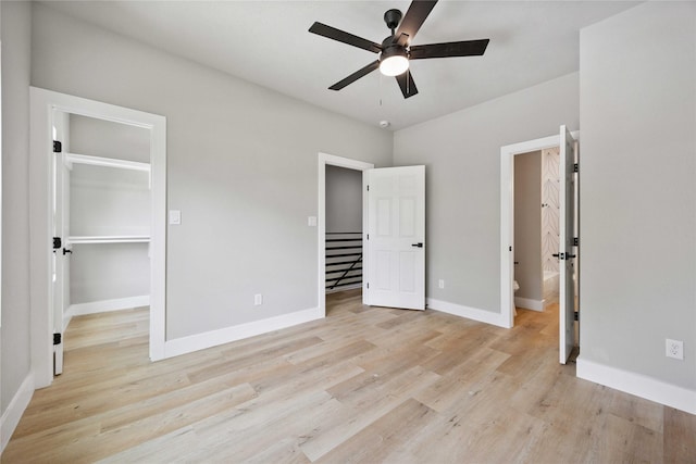 2409 Dolly Wright St, Houston, TX 77088 - unfurnished bedroom with a spacious closet, light wood finished floors, ensuite bathroom, and ceiling fan