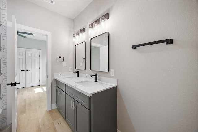 2409 Dolly Wright St, Houston, TX 77088 - bathroom with wood finished floors, double vanity, and ceiling fan