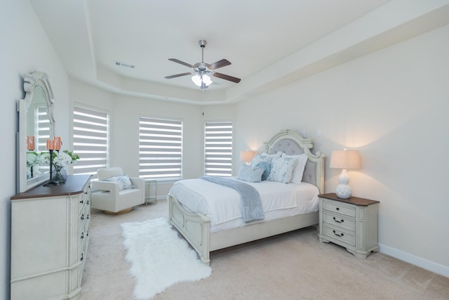 5506 Bellingen River Ln, Sugar Land, TX 77479 - bedroom featuring light carpet, a raised ceiling, and ceiling fan