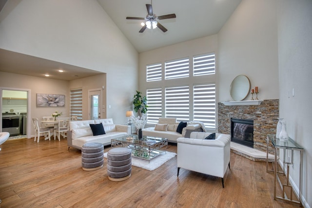 5506 Bellingen River Ln, Sugar Land, TX 77479 - living area featuring high vaulted ceiling, a ceiling fan, healthy amount of natural light, wood finished floors, and a fireplace