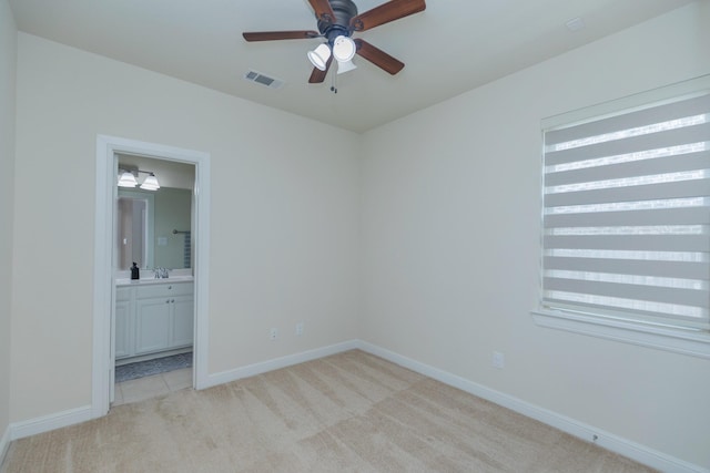 5506 Bellingen River Ln, Sugar Land, TX 77479 - unfurnished bedroom featuring light colored carpet, multiple windows, and ensuite bathroom
