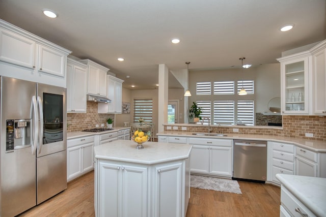 5506 Bellingen River Ln, Sugar Land, TX 77479 - kitchen featuring appliances with stainless steel finishes, a peninsula, decorative backsplash, white cabinetry, and recessed lighting