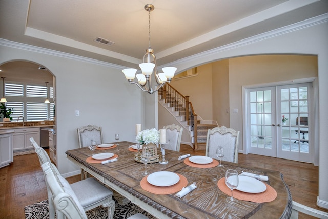 5506 Bellingen River Ln, Sugar Land, TX 77479 - dining area with arched walkways, a chandelier, stairs, plenty of natural light, and ornamental molding