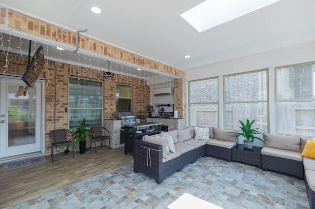5506 Bellingen River Ln, Sugar Land, TX 77479 - sunroom featuring a skylight, brick wall, a wall mounted air conditioner, and wood finished floors