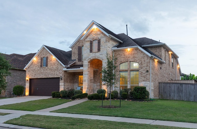 5506 Bellingen River Ln, Sugar Land, TX 77479 - french country style house with concrete driveway, brick siding, stone siding, and an attached garage