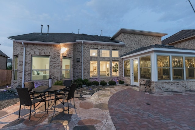 5506 Bellingen River Ln, Sugar Land, TX 77479 - rear view of house with a patio area, brick siding, and roof with shingles