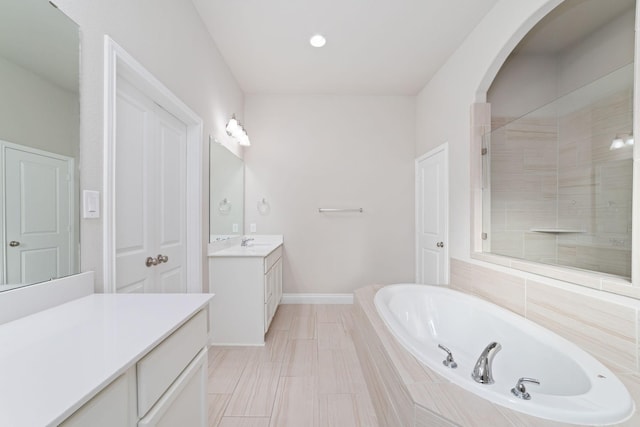 13727 Pedernales Ct, Cypress, TX 77429 - full bathroom featuring vanity, a garden tub, and a shower stall