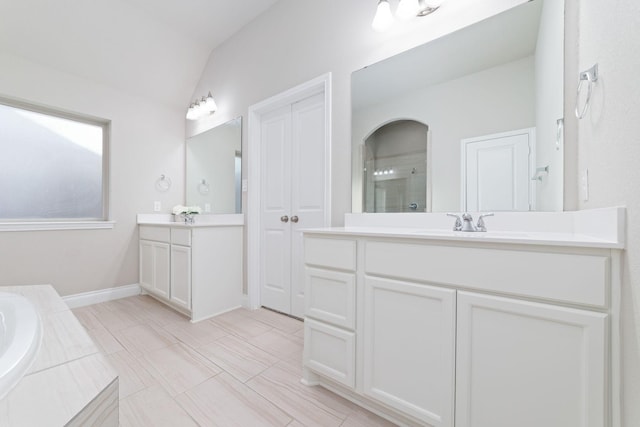 13727 Pedernales Ct, Cypress, TX 77429 - bathroom with two vanities, a stall shower, lofted ceiling, and a bath