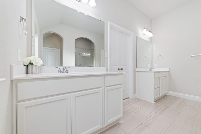 13727 Pedernales Ct, Cypress, TX 77429 - bathroom featuring a tile shower, two vanities, and vaulted ceiling