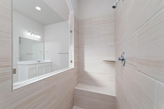 13727 Pedernales Ct, Cypress, TX 77429 - bathroom featuring a tile shower and vanity