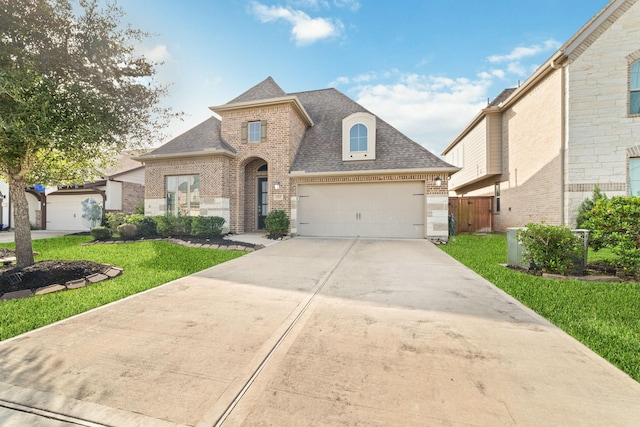 13727 Pedernales Ct, Cypress, TX 77429 - french provincial home with brick siding, a shingled roof, a garage, and driveway