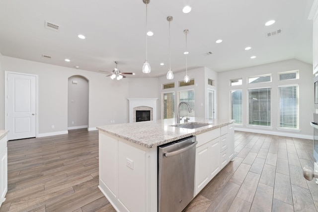 13727 Pedernales Ct, Cypress, TX 77429 - kitchen featuring stainless steel dishwasher, ceiling fan, light wood finished floors, white cabinets, and open floor plan