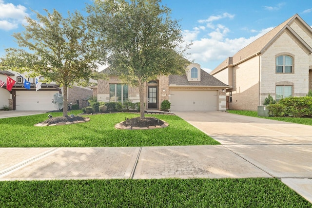 13727 Pedernales Ct, Cypress, TX 77429 - view of front facade featuring brick siding, driveway, an attached garage, a front yard, and a shingled roof