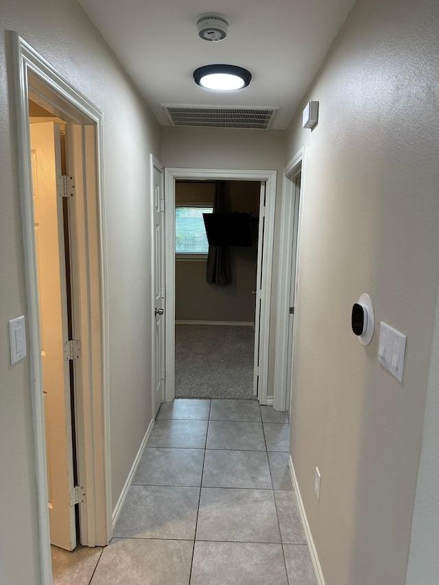 318 N 4th St, Alvin, TX 77511 - hall featuring light tile patterned flooring and baseboards