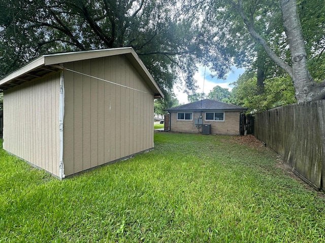 318 N 4th St, Alvin, TX 77511 - view of home's exterior featuring an outdoor structure and brick siding