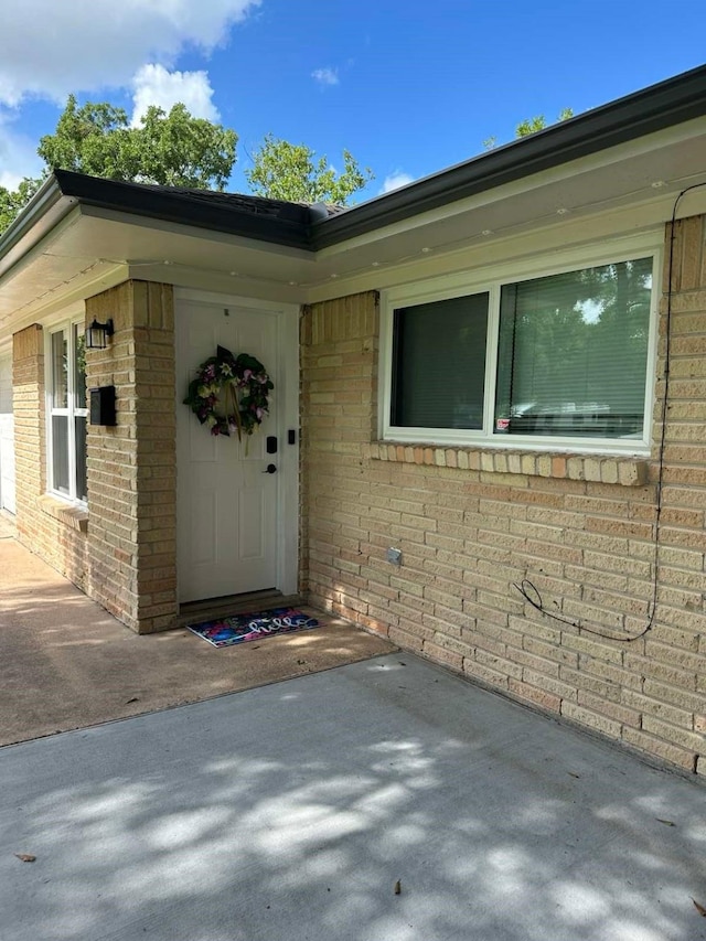 318 N 4th St, Alvin, TX 77511 - doorway to property with brick siding and a patio area