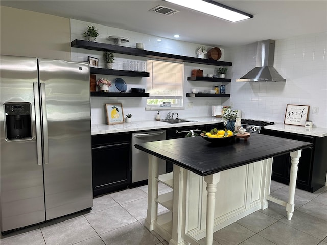 318 N 4th St, Alvin, TX 77511 - kitchen featuring appliances with stainless steel finishes, wall chimney range hood, and open shelves
