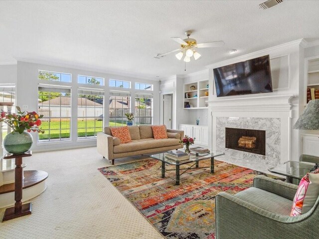 4614 Jamaica Dr, Sugar Land, TX 77479 - living room with ceiling fan, carpet floors, crown molding, a high end fireplace, and built in features