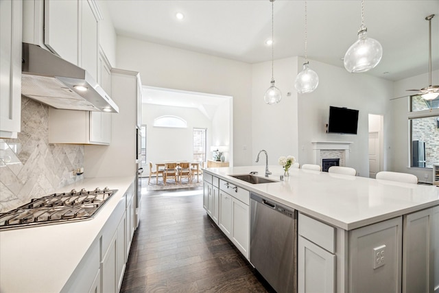 32311 Noble Creek Dr, Conroe, TX 77385 - kitchen with stainless steel appliances, open floor plan, tasteful backsplash, a fireplace, and an island with sink
