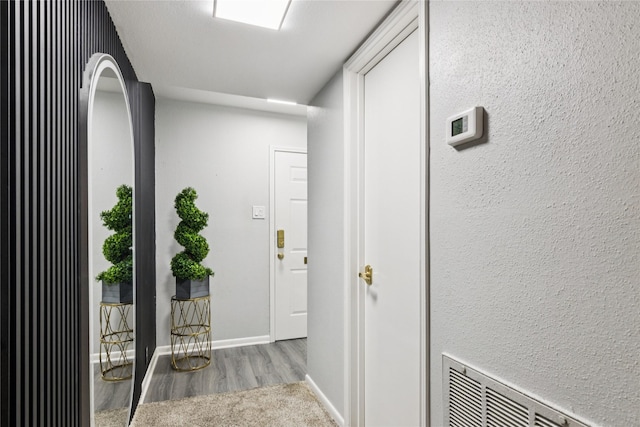 6429 Burgoyne Rd Unit 15, Houston, TX 77057 - hallway with wood finished floors and baseboards