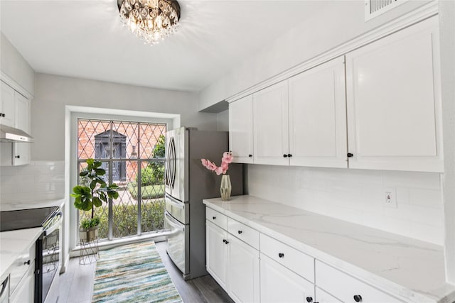 6429 Burgoyne Rd Unit 15, Houston, TX 77057 - kitchen with appliances with stainless steel finishes, white cabinets, under cabinet range hood, and decorative backsplash