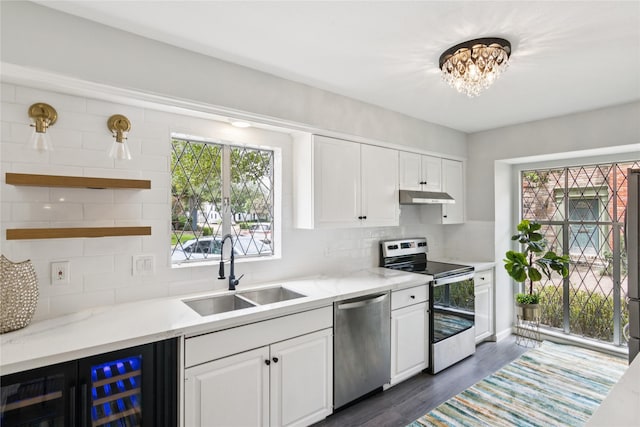 6429 Burgoyne Rd Unit 15, Houston, TX 77057 - kitchen featuring stainless steel appliances, under cabinet range hood, beverage cooler, open shelves, and white cabinets