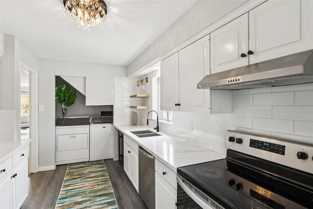 6429 Burgoyne Rd Unit 15, Houston, TX 77057 - kitchen featuring stainless steel appliances, washer and dryer, under cabinet range hood, and plenty of natural light