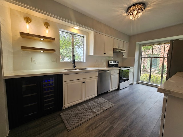 6429 Burgoyne Rd Unit 15, Houston, TX 77057 - kitchen featuring appliances with stainless steel finishes, beverage cooler, white cabinets, and tasteful backsplash